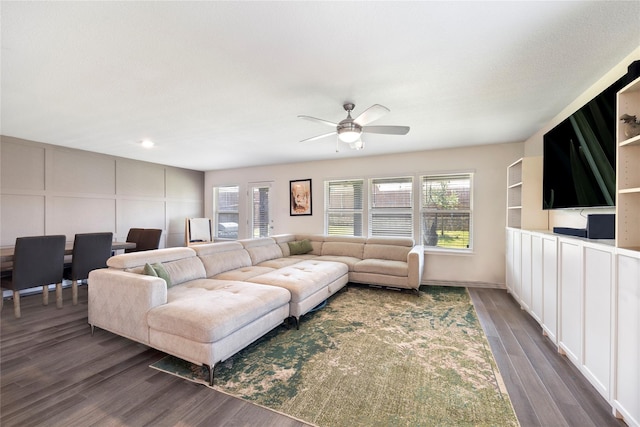 816 Adair Dr, Aubrey, TX 76227 - living area with dark wood finished floors, a ceiling fan, and a decorative wall