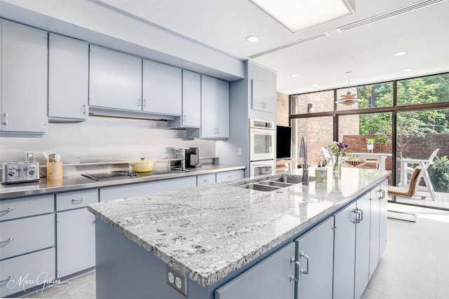 300 Pierremont Rd Unit 18, Shreveport, LA 71106 - kitchen with black electric cooktop, a kitchen island with sink, pendant lighting, double oven, and recessed lighting
