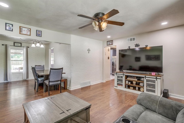 7063 Dover Ln, Richland Hills, TX 76118 - living area with wood finished floors, a ceiling fan, recessed lighting, and brick wall
