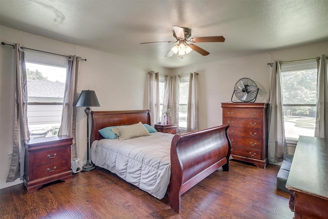 7063 Dover Ln, Richland Hills, TX 76118 - bedroom featuring multiple windows, dark wood-type flooring, and a ceiling fan