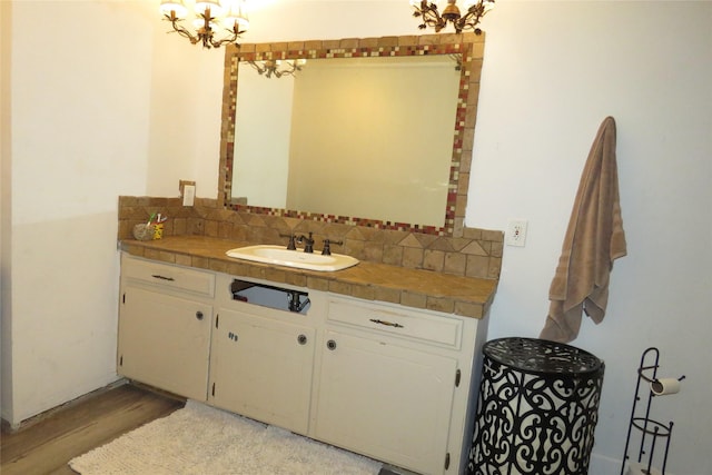 306 Country Club Dr, Joshua, TX 76058 - bathroom with decorative backsplash, wood finished floors, vanity, and a chandelier