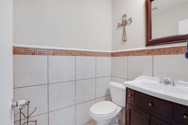 306 Country Club Dr, Joshua, TX 76058 - bathroom featuring vanity, tile walls, and a wainscoted wall