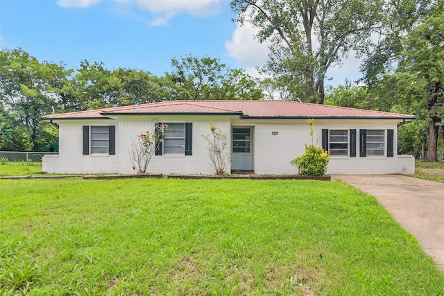 2050 Kyle Dr, Paris, TX 75460 - ranch-style house featuring brick siding, a metal roof, and driveway