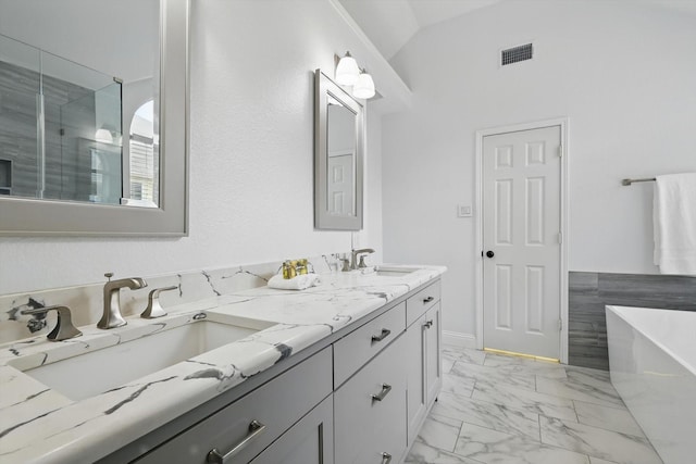 4704 Misty Ridge Dr, Fort Worth, TX 76137 - bathroom with a freestanding bath, double vanity, marble look tile flooring, lofted ceiling, and a shower