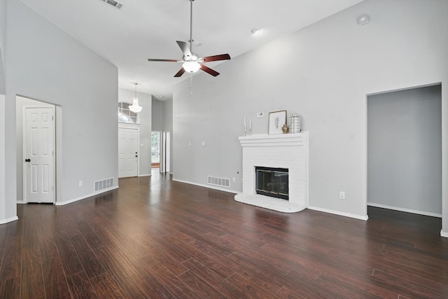 4704 Misty Ridge Dr, Fort Worth, TX 76137 - unfurnished living room with a towering ceiling, a ceiling fan, a fireplace, and wood finished floors