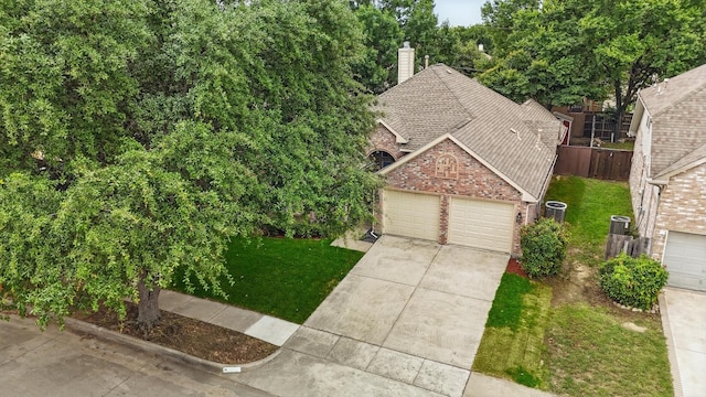 4704 Misty Ridge Dr, Fort Worth, TX 76137 - view of front of home with brick siding, concrete driveway, a chimney, a garage, and roof with shingles
