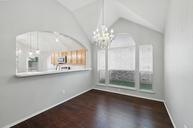 4704 Misty Ridge Dr, Fort Worth, TX 76137 - unfurnished dining area with lofted ceiling, dark wood-type flooring, and a chandelier