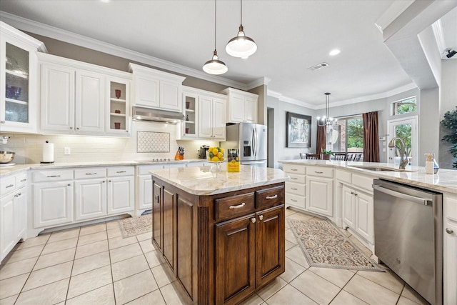5651 Lucca Dr, Fort Worth, TX 76140 - kitchen featuring stainless steel appliances, light tile patterned floors, white cabinetry, crown molding, and backsplash