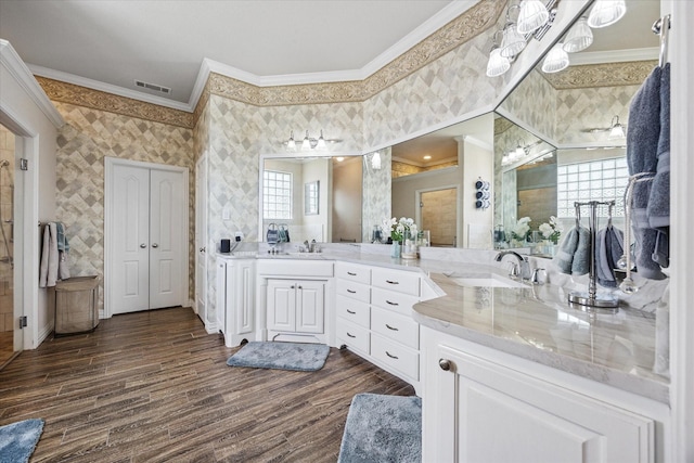 5651 Lucca Dr, Fort Worth, TX 76140 - bathroom with crown molding, double vanity, wood finished floors, and wallpapered walls