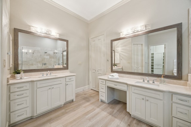 205 Suncreek Dr, Allen, TX 75013 - full bathroom featuring crown molding, a shower stall, two vanities, and wood finished floors