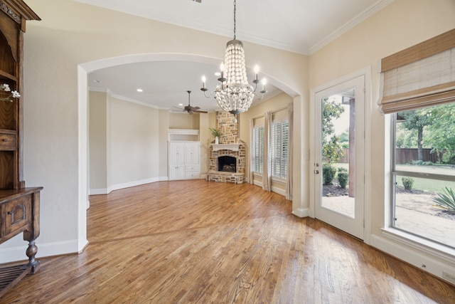 205 Suncreek Dr, Allen, TX 75013 - unfurnished living room featuring a ceiling fan, arched walkways, crown molding, light wood-style flooring, and recessed lighting