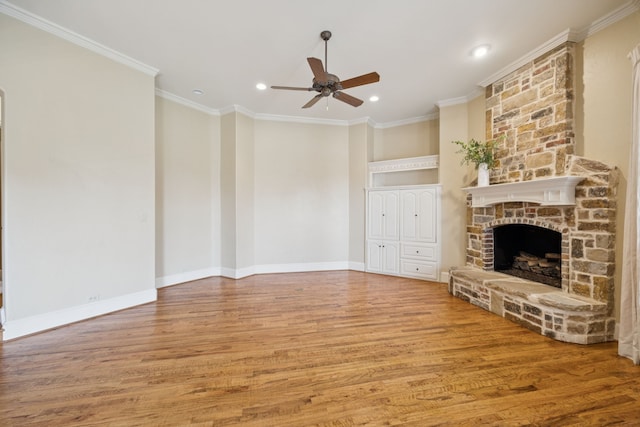 205 Suncreek Dr, Allen, TX 75013 - unfurnished living room featuring a ceiling fan, wood finished floors, a stone fireplace, recessed lighting, and crown molding