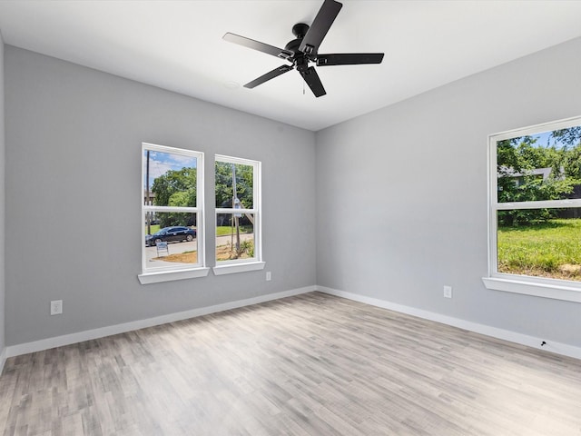 1609 E Bluff St, Fort Worth, TX 76102 - unfurnished room with healthy amount of natural light, wood finished floors, and a ceiling fan