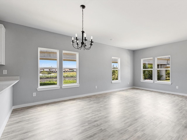 1609 E Bluff St, Fort Worth, TX 76102 - unfurnished dining area with a chandelier and light wood finished floors