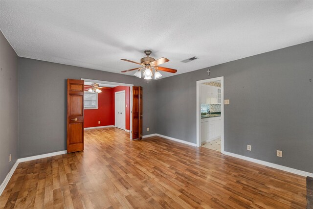 3808 Leland Ave, Waco, TX 76708 - spare room featuring plenty of natural light, wood finished floors, a ceiling fan, and a textured ceiling