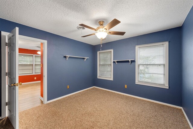 3808 Leland Ave, Waco, TX 76708 - unfurnished bedroom featuring light wood-type flooring, track lighting, a closet, a textured wall, and ceiling fan