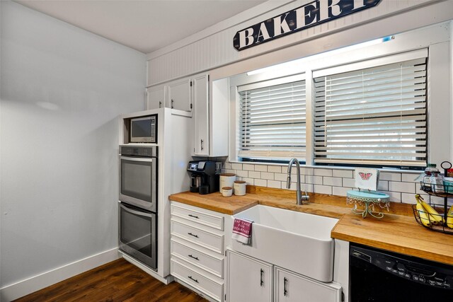 714 W Ball St, Weatherford, TX 76086 - kitchen featuring butcher block counters, black dishwasher, backsplash, stainless steel double oven, and dark wood-style flooring