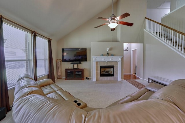 1013 Lilac Ln, Desoto, TX 75115 - carpeted living room with high vaulted ceiling, ceiling fan, stairway, and a tiled fireplace