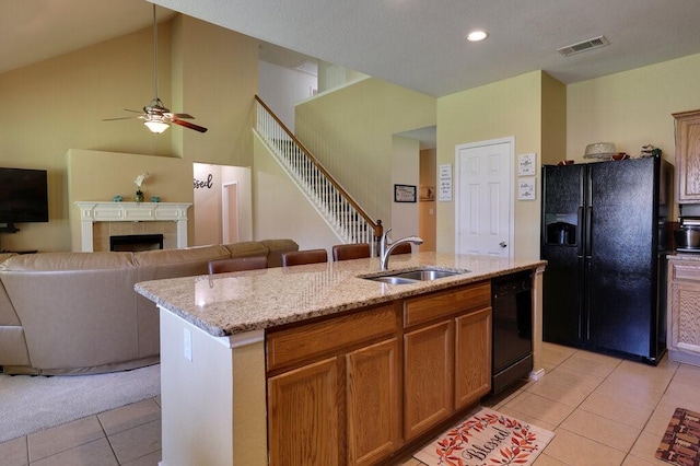 1013 Lilac Ln, Desoto, TX 75115 - kitchen with black appliances, light tile patterned flooring, open floor plan, light stone counters, and lofted ceiling
