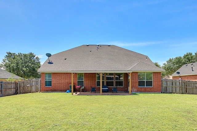 1013 Lilac Ln, Desoto, TX 75115 - back of property with a patio, a fenced backyard, brick siding, and roof with shingles