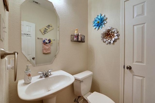 1013 Lilac Ln, Desoto, TX 75115 - half bathroom with a sink and toilet