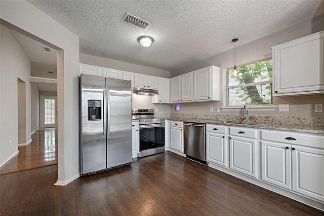 10257 Tustin Ter, Fort Worth, TX 76108 - kitchen with appliances with stainless steel finishes, dark wood-style floors, white cabinetry, light stone countertops, and a textured ceiling