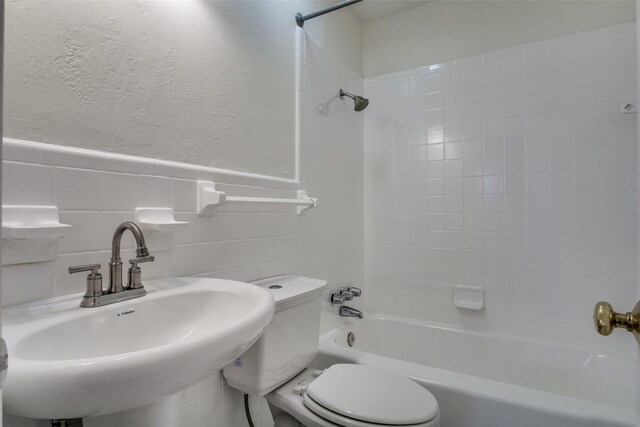 5861 Coleman St, Westworth Village, TX 76114 - full bathroom featuring tub / shower combination, a textured wall, wainscoting, and tile walls