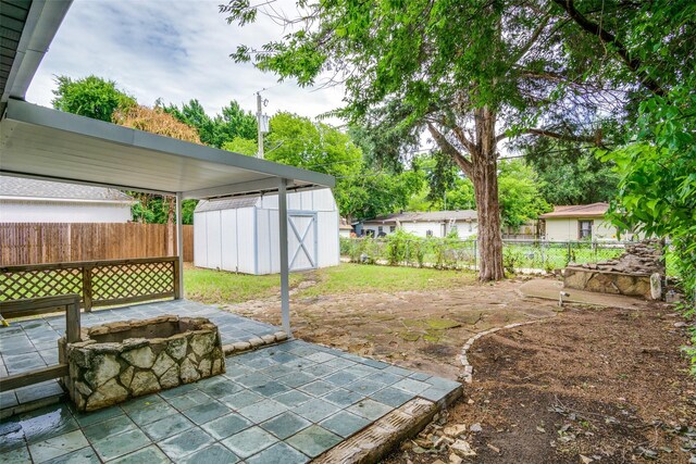 5861 Coleman St, Westworth Village, TX 76114 - fenced backyard featuring a shed, an outdoor fire pit, and a patio