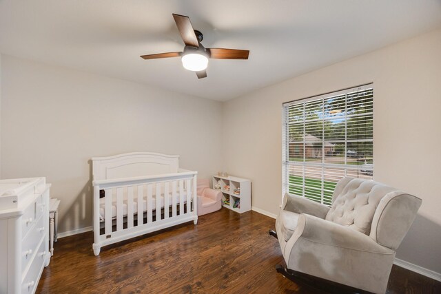 7122 Holden Dr, Rockwall, TX 75087 - bedroom with wood finished floors, a crib, and a ceiling fan