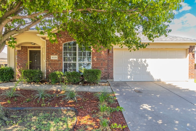 8128 Guadalupe Rd, Arlington, TX 76002 - view of front of house featuring brick siding, driveway, a garage, and roof with shingles