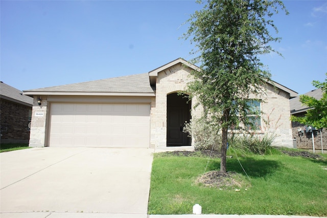 16428 Milwaukee St, Justin, TX 76247 - ranch-style home with concrete driveway, stone siding, a front yard, and an attached garage