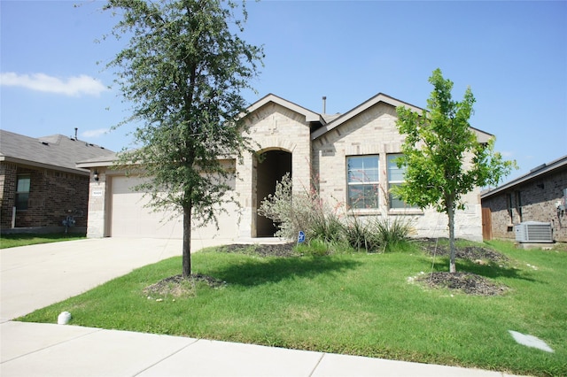 16428 Milwaukee St, Justin, TX 76247 - ranch-style house with concrete driveway, a garage, a front yard, and stone siding