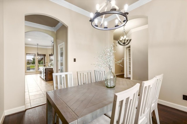 18044 Langford Ln, Talty, TX 75126 - dining room featuring a chandelier, ornamental molding, arched walkways, and wood finished floors