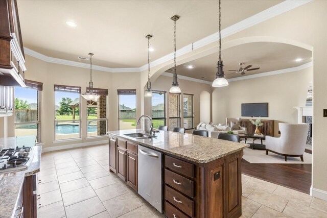 18044 Langford Ln, Talty, TX 75126 - kitchen with appliances with stainless steel finishes, ceiling fan, arched walkways, light tile patterned floors, and crown molding