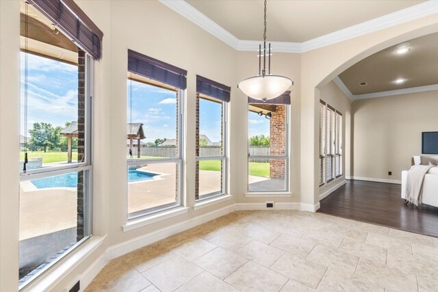 18044 Langford Ln, Talty, TX 75126 - unfurnished dining area with ornamental molding, arched walkways, and tile patterned flooring
