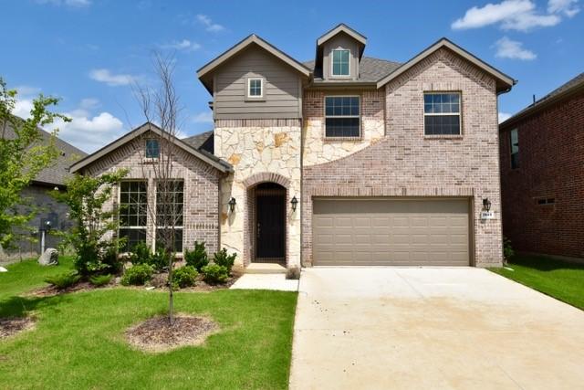2605 Donella Dr, Denton, TX 76207 - view of front of house with brick siding, an attached garage, concrete driveway, and a front lawn