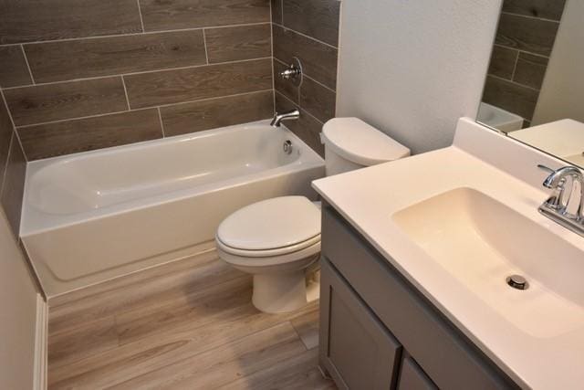 2605 Donella Dr, Denton, TX 76207 - full bathroom with wood finished floors, vanity, and washtub / shower combination