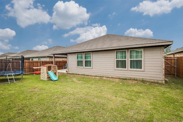 632 Peshtigo Rd, Justin, TX 76247 - back of property with a trampoline, a fenced backyard, and a playground