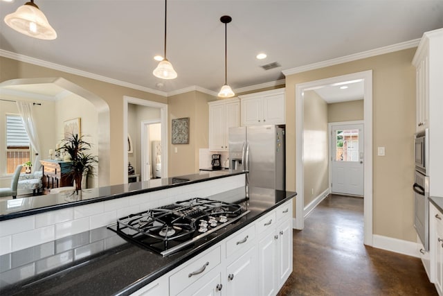 2309 Ryan Ave, Fort Worth, TX 76110 - kitchen featuring stainless steel appliances, arched walkways, dark countertops, white cabinets, and ornamental molding