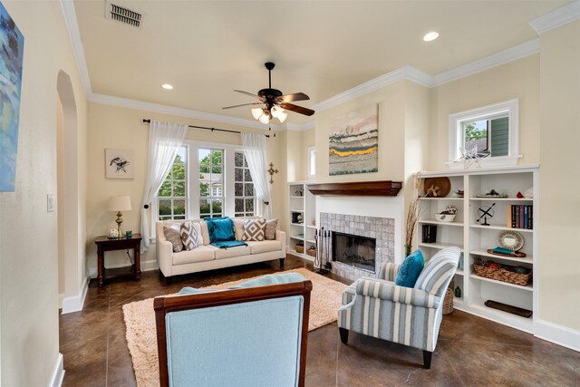2309 Ryan Ave, Fort Worth, TX 76110 - living room featuring ceiling fan, a tile fireplace, ornamental molding, arched walkways, and recessed lighting