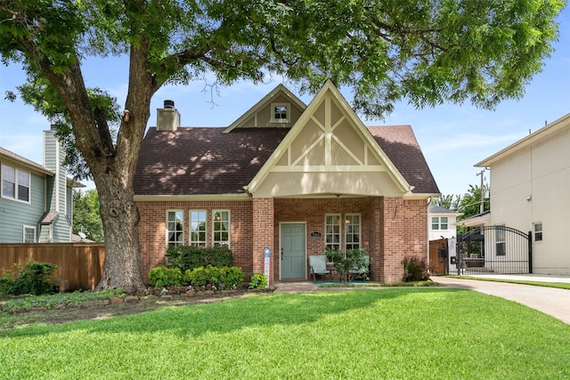 2309 Ryan Ave, Fort Worth, TX 76110 - tudor home with brick siding, a gate, roof with shingles, and a chimney