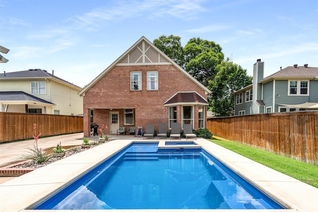 2309 Ryan Ave, Fort Worth, TX 76110 - back of house featuring brick siding, a fenced backyard, a patio, and an in-ground hot tub