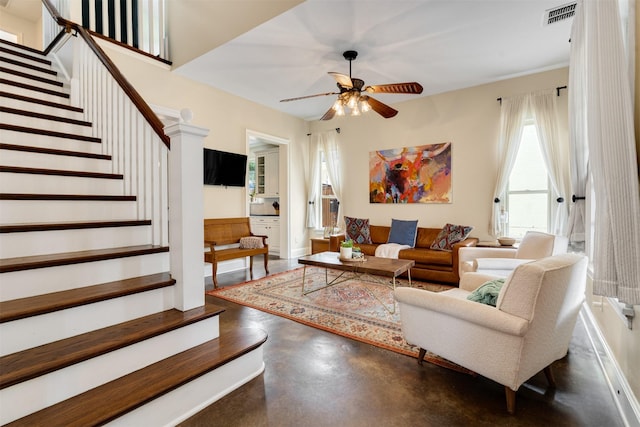 2309 Ryan Ave, Fort Worth, TX 76110 - living room featuring concrete floors, ceiling fan, and stairway