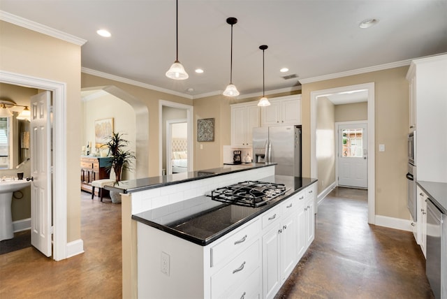 2309 Ryan Ave, Fort Worth, TX 76110 - kitchen featuring appliances with stainless steel finishes, arched walkways, dark countertops, a center island, and finished concrete floors