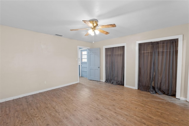 310 Lexington Ave, Abilene, TX 79605 - unfurnished bedroom featuring two closets, light wood-type flooring, and ceiling fan