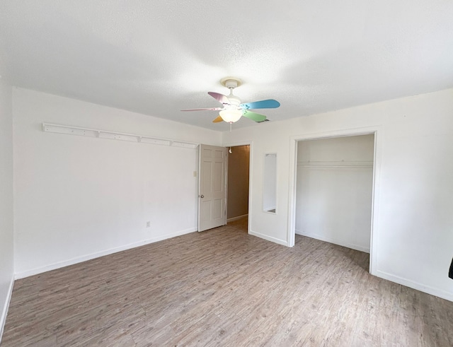 310 Lexington Ave, Abilene, TX 79605 - unfurnished bedroom with wood finished floors, a textured ceiling, a closet, and a ceiling fan