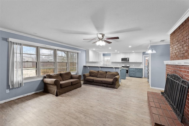 310 Lexington Ave, Abilene, TX 79605 - living area featuring crown molding, ceiling fan, light wood-style flooring, a fireplace, and recessed lighting