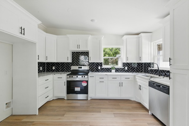903 N Miller St, Decatur, TX 76234 - kitchen featuring appliances with stainless steel finishes, decorative backsplash, white cabinets, and light countertops
