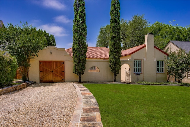 6812 Clayton Ave, Dallas, TX 75214 - mediterranean / spanish-style house featuring a front yard, a chimney, stucco siding, a tile roof, and gravel driveway