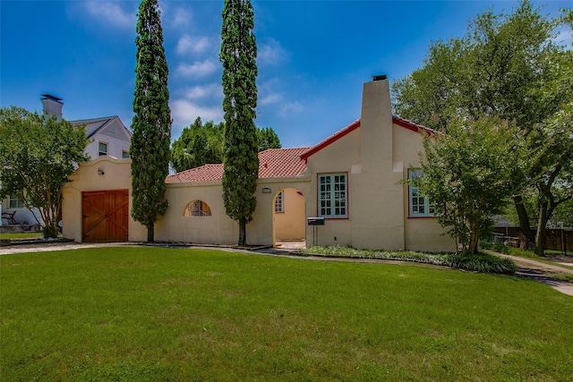 6812 Clayton Ave, Dallas, TX 75214 - mediterranean / spanish-style house with a garage, a front lawn, a tile roof, and stucco siding